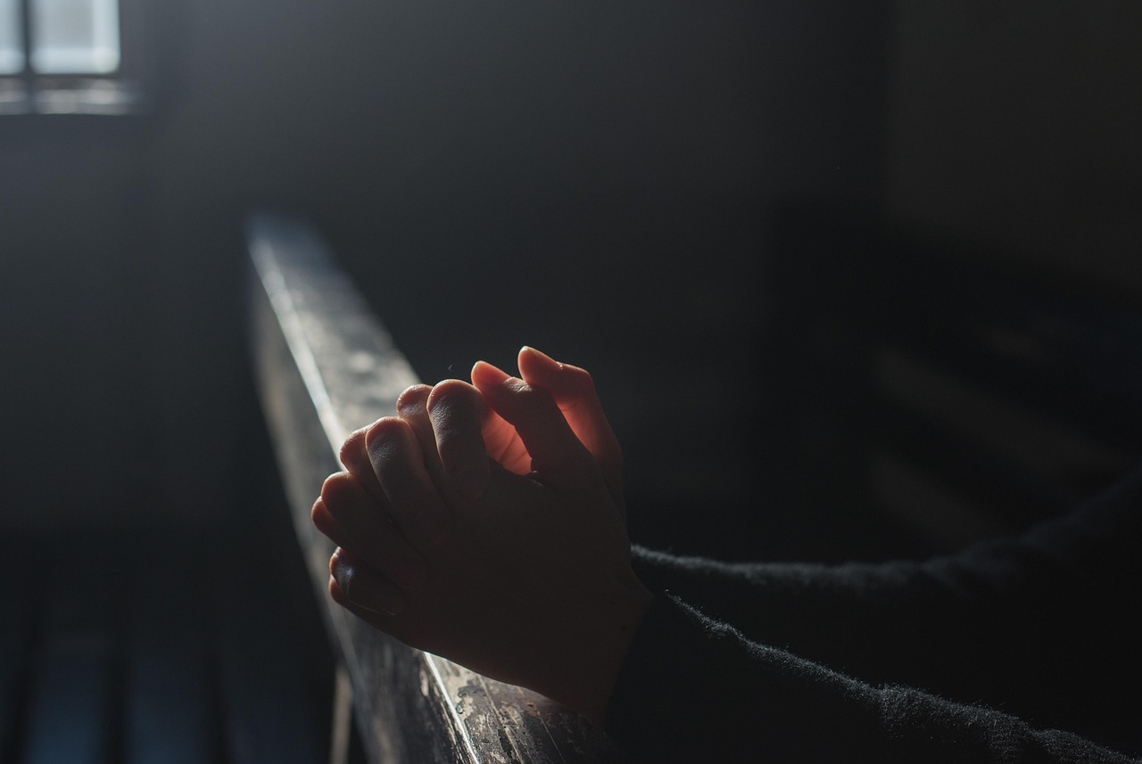 prayer hands in church light faith hope community